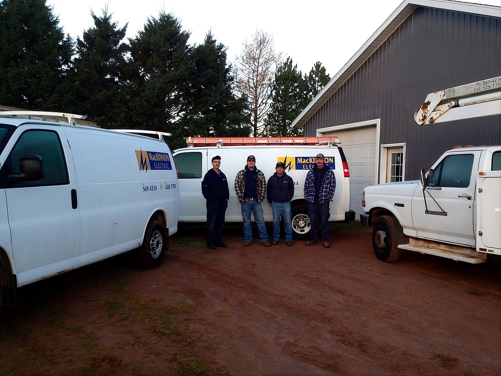The MacKinnon Electric crew standing in front of the company vans